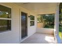 Inviting front porch featuring tile flooring, a white railing, and ample natural light at 2210 Grant Ave, Eustis, FL 32726