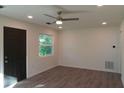 Bright living room with stylish wood flooring, recessed lighting, and neutral paint at 2210 Grant Ave, Eustis, FL 32726