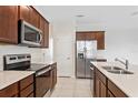 Modern kitchen featuring stainless steel appliances, sleek countertops and ample cabinet space at 2365 Palm Park Loop, Clermont, FL 34714