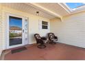 Inviting front porch with seating and covered entry to the home at 3176 Atwell Ave, The Villages, FL 32162