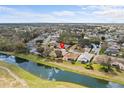 Aerial perspective of homes near a picturesque waterway at 321 Ranchwood Dr, Leesburg, FL 34748