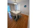 Bright dining room featuring hardwood floors, a white table and chairs, and natural lighting at 3297 Riverton Rd, The Villages, FL 32162