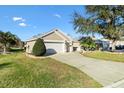 Well maintained single story home with a large front yard and a two-car garage at 3529 Sterling St, The Villages, FL 32162