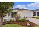 Charming home featuring a two-car garage, beautiful landscaping, and a well-maintained lawn at 620 Vagabond St, The Villages, FL 32163