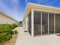Back patio enclosed with screen, offering a comfortable space for relaxation and enjoying outdoors at 620 Vagabond St, The Villages, FL 32163