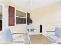 Cozy screened patio featuring comfortable seating, neutral decor, and relaxing ambiance at 620 Vagabond St, The Villages, FL 32163