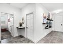 Hallway with hard floors and minimal decor leading to various rooms at 7193 Dilly Lake Ave, Groveland, FL 34736