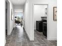 Hallway with hard floors and a view of the laundry room at 7193 Dilly Lake Ave, Groveland, FL 34736