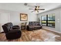 Comfortable living room with hardwood floors, a ceiling fan, and a view to the outdoors at 8230 Se 23Rd Dr, Webster, FL 33597