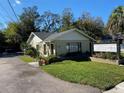 Charming one story commercial building featuring well maintained lawn, palm tree and elegant signage at 911 N Donnelly St, Mount Dora, FL 32757