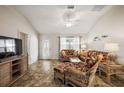 Bright living room with comfortable seating, ceiling fan, and lots of natural light at 9243 Se 171St Cooper Loop, The Villages, FL 32162