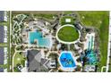 Aerial view of resort-style community amenities, including pools, water slides, and recreational areas at 1614 Moon Valley Dr, Champions Gate, FL 33896