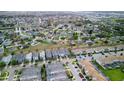 An aerial view of a residential neighborhood showcasing lush greenery and well-maintained homes at 1614 Moon Valley Dr, Champions Gate, FL 33896