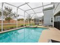 Inviting backyard pool area featuring a screened-in enclosure and outdoor seating at 1614 Moon Valley Dr, Champions Gate, FL 33896