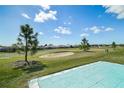 View of the backyard overlooking the community golf course from the outdoor patio at 17051 Se 115Th Terrace Rd, Summerfield, FL 34491