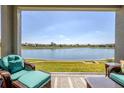 Relaxing screened lanai overlooking a serene pond with comfortable seating and tranquil views at 17108 Se 111Th Terrace Rd, Summerfield, FL 34491