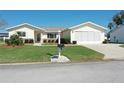 Well maintained, single story home shows manicured lawn, mature shrubs and inviting curb appeal at 17937 Se 107Th Ter, Summerfield, FL 34491