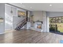 Open living room with a decorative fireplace and wood-look flooring at 18944 Bates Ave, Eustis, FL 32736