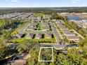 Aerial view of a community with lush greenery, featuring a vacant lot ready for building at 2030 N Highland St, Mount Dora, FL 32757