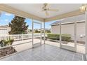 Relaxing screened-in porch with a ceiling fan and a view of the neighborhood at 2245 Hanover Ter, The Villages, FL 32162