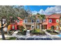 A vibrant townhome with a landscaped front yard and colorful exteriors at 2754 Sun Key Pl, Kissimmee, FL 34747