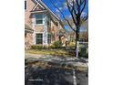 Side view of townhouse featuring a sidewalk, landscaping, and ample parking in front at 3417 Westchester Square Blvd # 204, Orlando, FL 32835