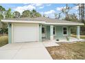 Charming single-story home with a well-manicured lawn and a one-car garage at 35 Sequoia Loop Ct, Ocklawaha, FL 32179