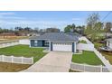 Single-story home with manicured lawn and attached two car garage at 54 Pecan Pass, Ocala, FL 34472