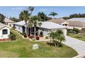 An aerial view of a well-maintained home showcasing a nicely manicured lawn and paved driveway at 5952 Brittania Blvd, Tavares, FL 32778