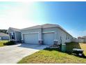 Well-maintained, single-story home featuring a two-car garage and a tidy front lawn at 6853 Se 3Rd Loop, Ocala, FL 34472