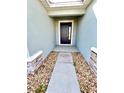 Inviting entryway with stone accents, a modern front door, and a well-maintained walkway at 6853 Se 3Rd Loop, Ocala, FL 34472