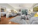 Spacious living room featuring neutral colors, hardwood floors, and sliding glass doors at 853 Abaco Path, The Villages, FL 32163