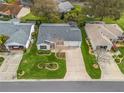 Aerial view of property showcasing meticulously maintained landscaping and ample driveway space at 893 Halstead Ter, The Villages, FL 32162