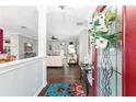 Inviting entryway with dark wood floors and a view into the living room at 9894 Se 138Th Loop, Summerfield, FL 34491