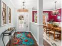 Inviting entryway with decorative mirrors and a glimpse into the formal dining room at 9894 Se 138Th Loop, Summerfield, FL 34491