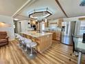 Modern kitchen with an island, stainless steel appliances, and a stylish range hood at 104 Chestnut St, Leesburg, FL 34748