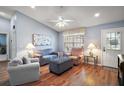 Bright living room showcasing hardwood floors, comfortable seating, ceiling fan and lots of natural light at 16840 Se 97Th Wildwood Ct, The Villages, FL 32162