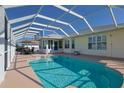 A refreshing screened-in pool, perfect for outdoor relaxation and entertaining near the home at 17490 Se 110Th Ter, Summerfield, FL 34491