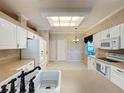 Bright kitchen features white cabinets, stainless steel appliances, and a breakfast nook at 2185 Caxton Ave, Clermont, FL 34711