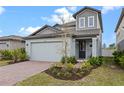Stylish two-story home with a brick driveway and inviting front porch at 2289 Mystic Maze Ln, Minneola, FL 34715