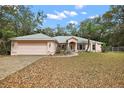 Charming single-story home featuring a well-maintained front yard and attached two car garage at 2541 Lake Griffin Rd, Lady Lake, FL 32159