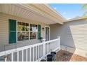 Inviting front porch with decorative railings and a view of the well-maintained exterior at 2738 Privada Dr, The Villages, FL 32162