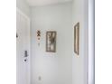 Hallway with neutral paint, art fixtures, and a white door at 3011 George Mason Ave # 3, Winter Park, FL 32792