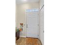 Inviting entryway with a white front door, transom window, and wood-look flooring at 3368 Parkchester Square Blvd # 104, Orlando, FL 32835