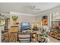 Cozy living room features a ceiling fan, wood flooring, and natural light at 3368 Parkchester Square Blvd # 104, Orlando, FL 32835