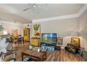 Bright living room featuring wood-look floors and an open layout with a kitchen view at 3368 Parkchester Square Blvd # 104, Orlando, FL 32835
