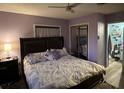 Cozy bedroom featuring a ceiling fan, closet, and an ensuite bathroom for added convenience at 43648 S Island Dr, Paisley, FL 32767