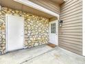 Covered entrance featuring stone wall, white door and welcome mat at 508 Boxelder Ave, Altamonte Springs, FL 32714