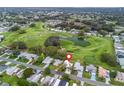 Aerial view of home close to golf course and pond at 511 Bonita Dr, Lady Lake, FL 32159