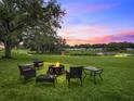 Inviting outdoor seating area with fire pit perfect for entertaining with lush green surroundings at 511 Bonita Dr, Lady Lake, FL 32159
